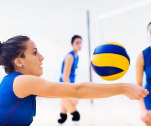 Player spikes ball, showcasing skills in volleyball