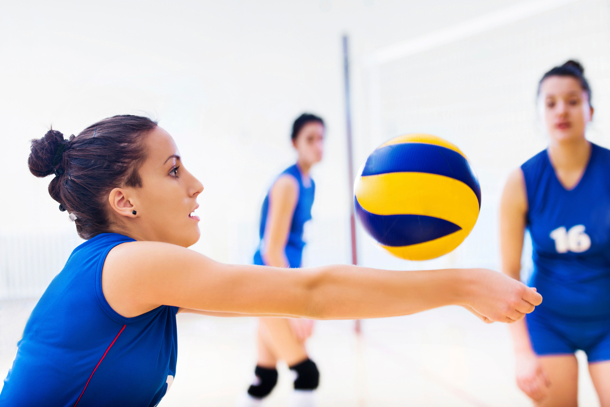 Player spikes ball, showcasing skills in volleyball